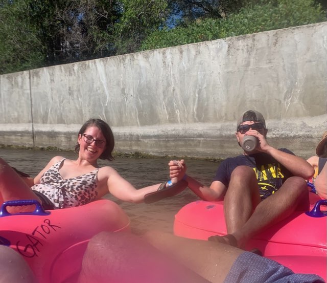 Two residents on the water in pink floaties