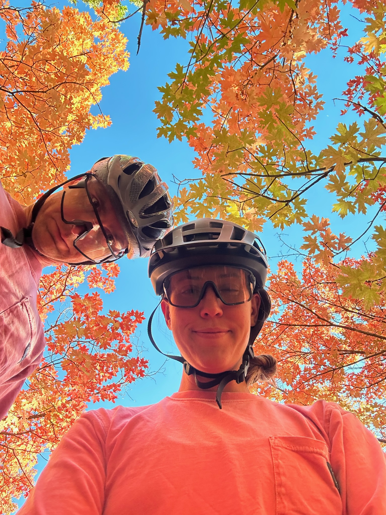 Two people in bike riding helmets in a selfie