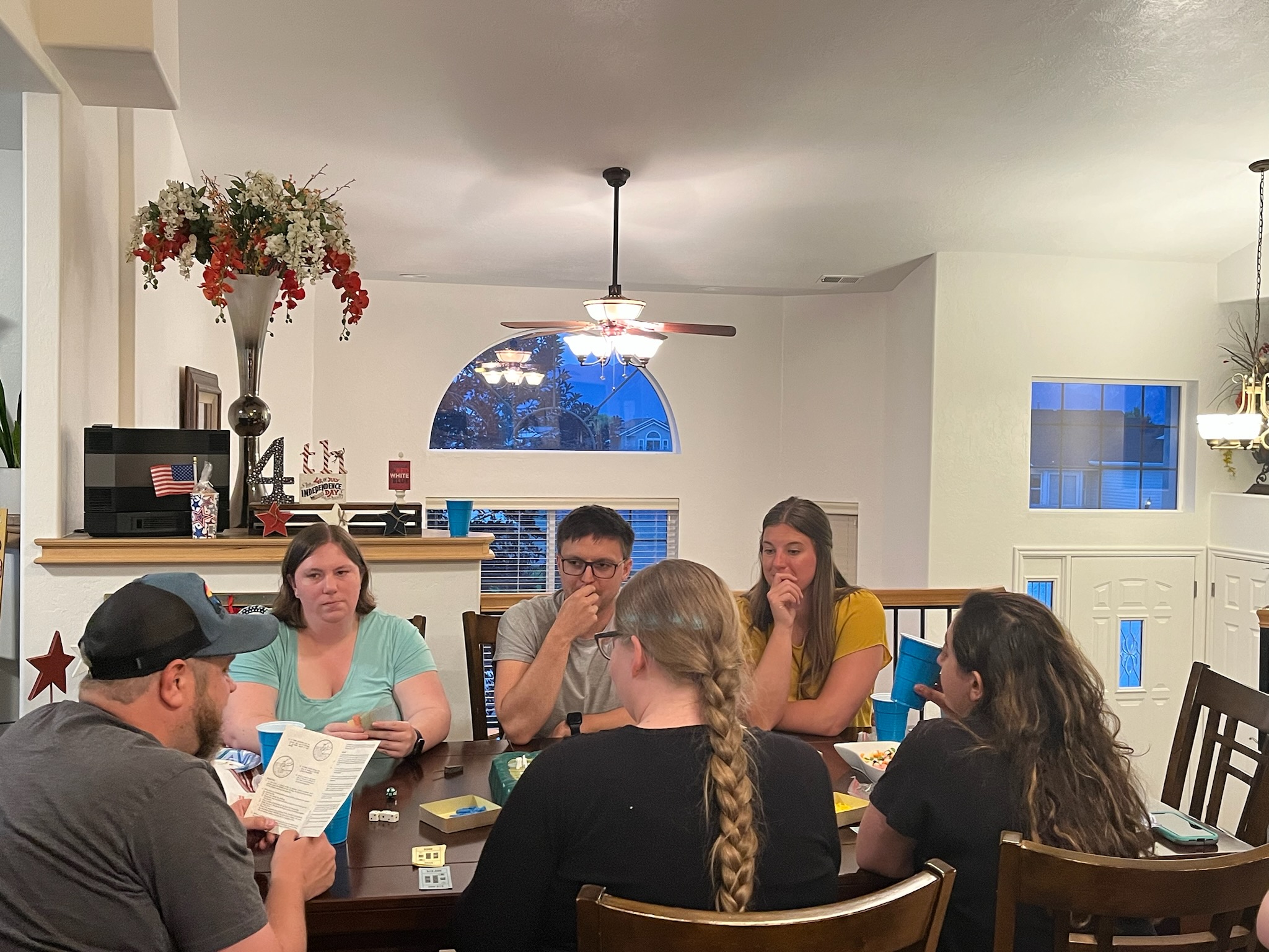 Group gathered at a dinner table for board games
